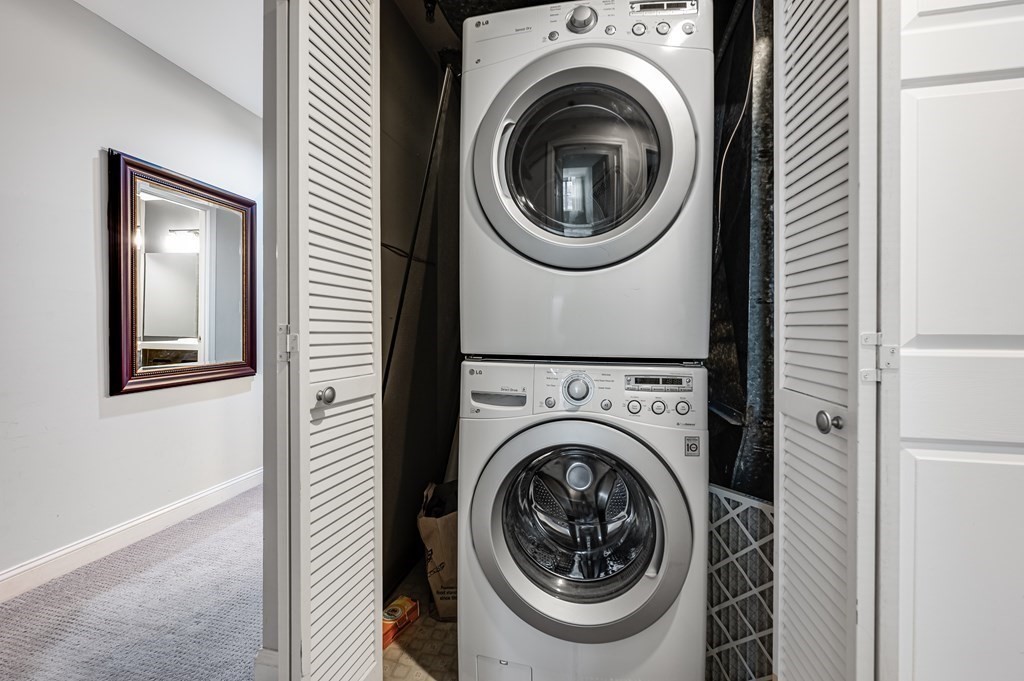 116 Milton Street, Unit 231 Dedham, MA 02026 - Photo 26 of 27 a view of a hallway with washer and dryer