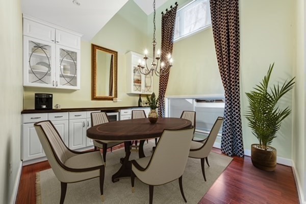 116 Milton Street, Unit 231 Dedham, MA 02026 - Photo 4 of 27 a view of a dining room with furniture and wooden floor