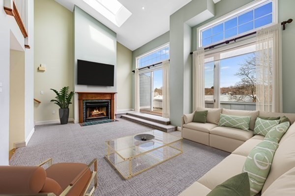116 Milton Street, Unit 231 Dedham, MA 02026 - Photo 7 of 27 a living room with furniture a flat screen tv and a fireplace