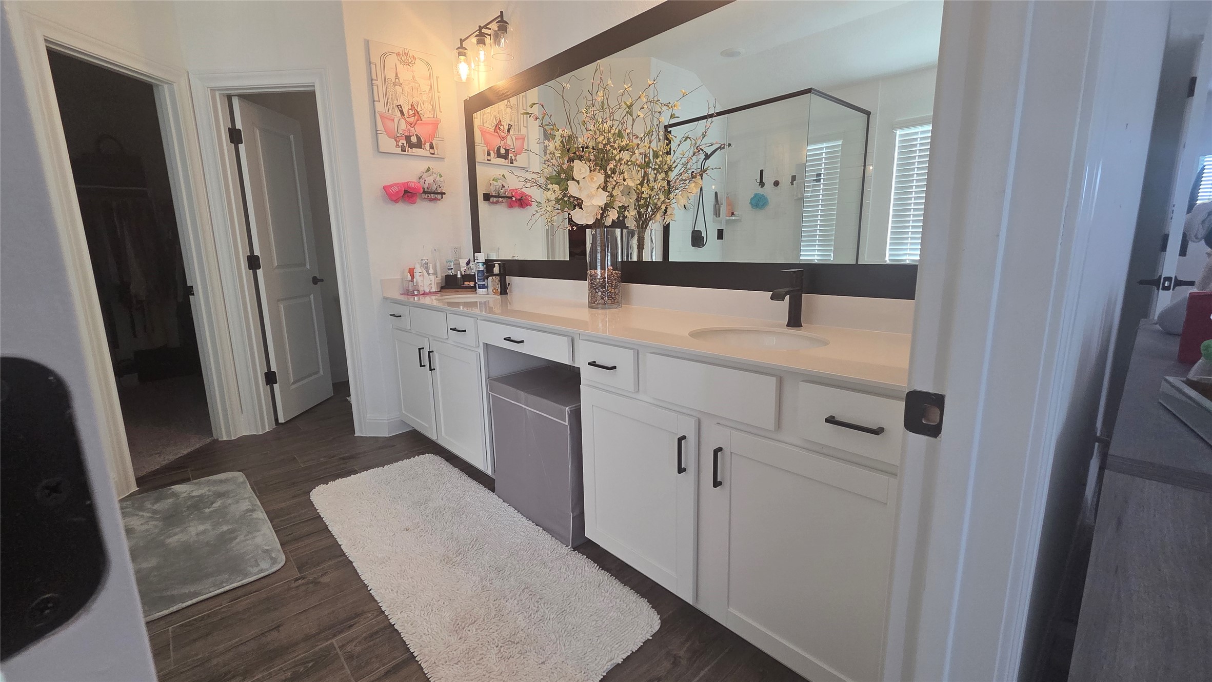 125 Raleigh Drive Georgetown, TX 78633 - Photo 18 of 30 Bathroom featuring double vanity, dark wood finished floors, and a shower stall