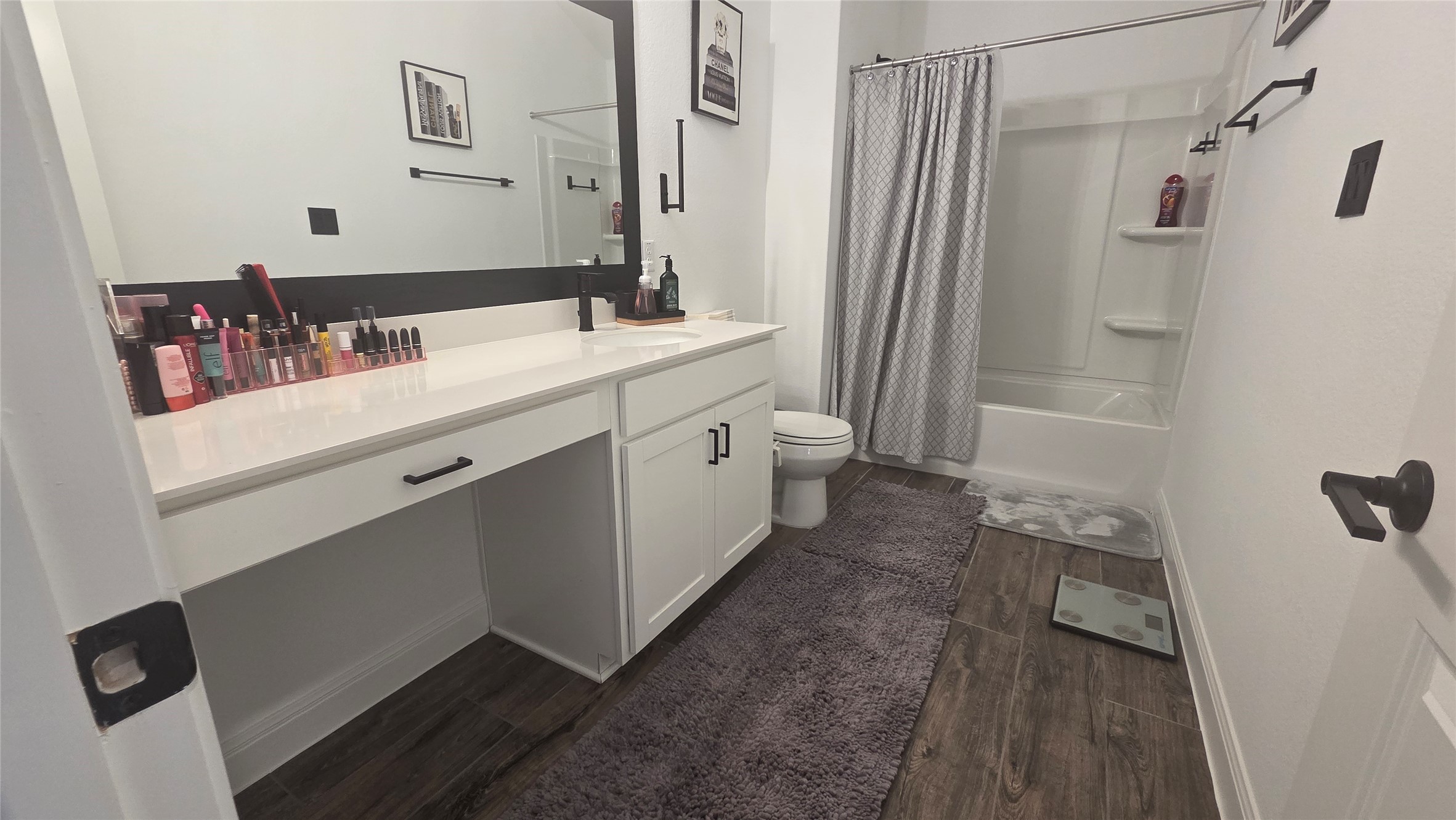 125 Raleigh Drive Georgetown, TX 78633 - Photo 20 of 30 Full bathroom featuring vanity, shower / bathtub combination with curtain, and dark wood-style flooring