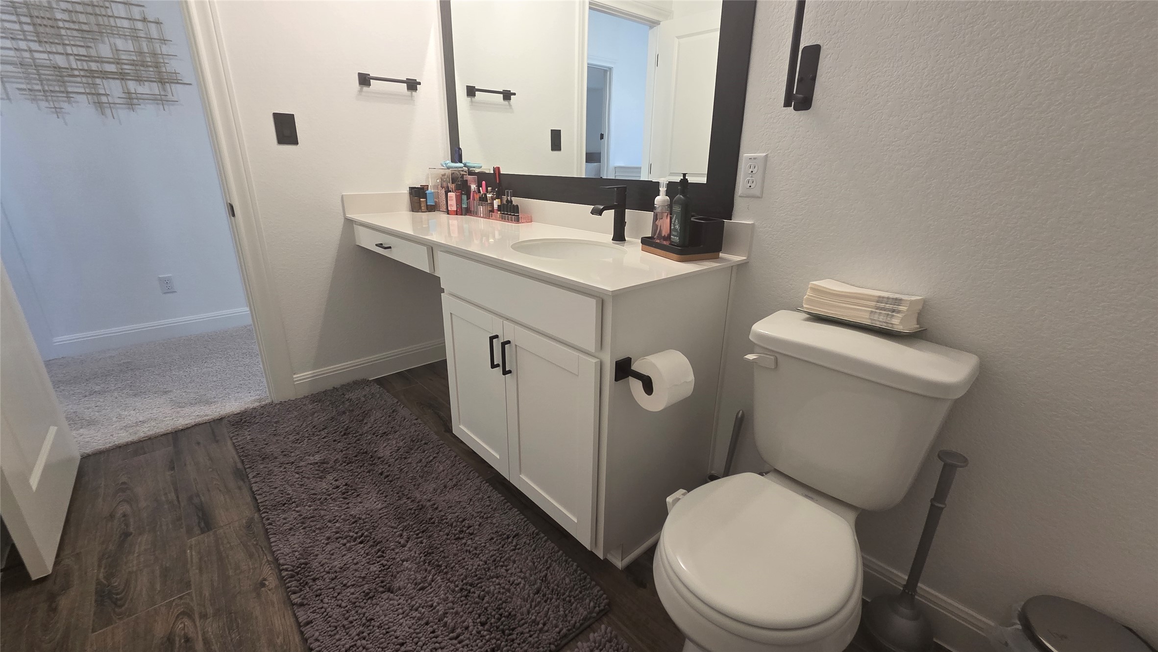 125 Raleigh Drive Georgetown, TX 78633 - Photo 21 of 30 Bathroom featuring vanity and dark wood finished floors