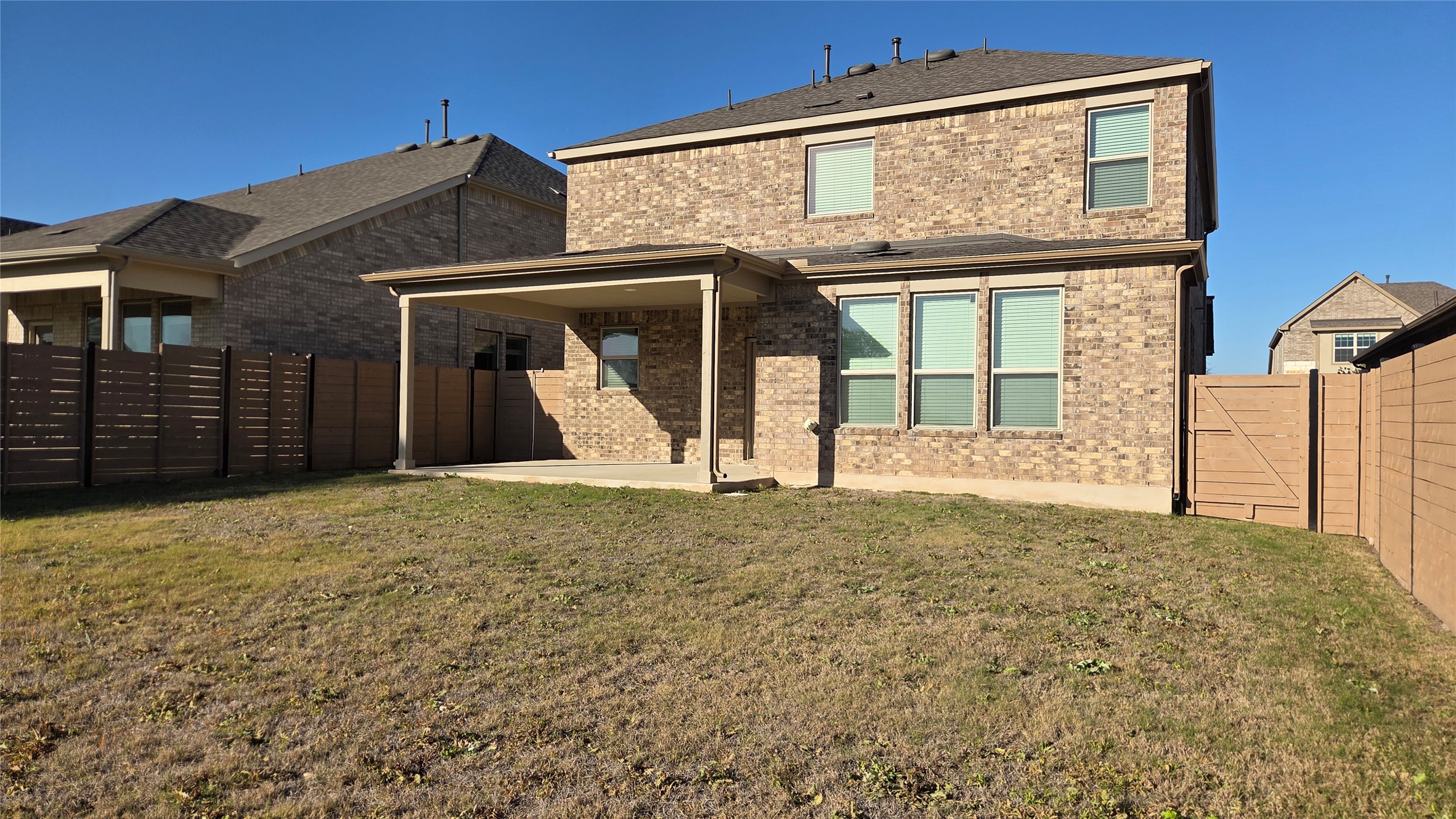 125 Raleigh Drive Georgetown, TX 78633 - Photo 29 of 30 Rear view of property featuring brick siding, a patio, and a fenced backyard