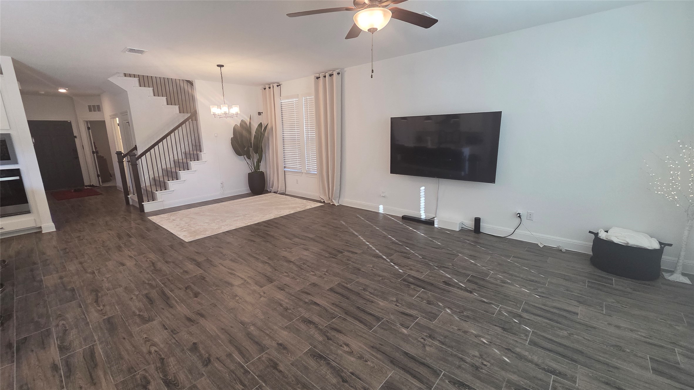 125 Raleigh Drive Georgetown, TX 78633 - Photo 3 of 30 Unfurnished living room with wood finish floors, ceiling fan, and suspended lighting