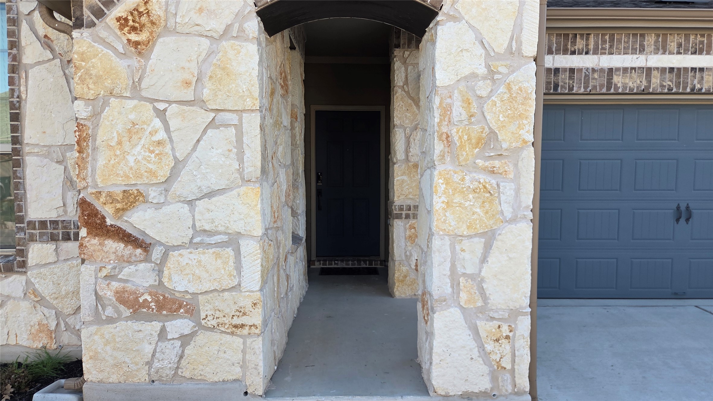 125 Raleigh Drive Georgetown, TX 78633 - Photo 6 of 30 Property entrance with stone siding and a garage