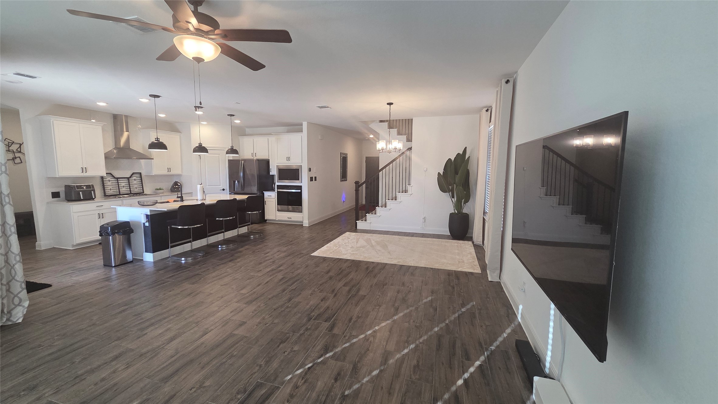 125 Raleigh Drive Georgetown, TX 78633 - Photo 7 of 30 Living area with ceiling fan, dark wood-type flooring, and a chandelier