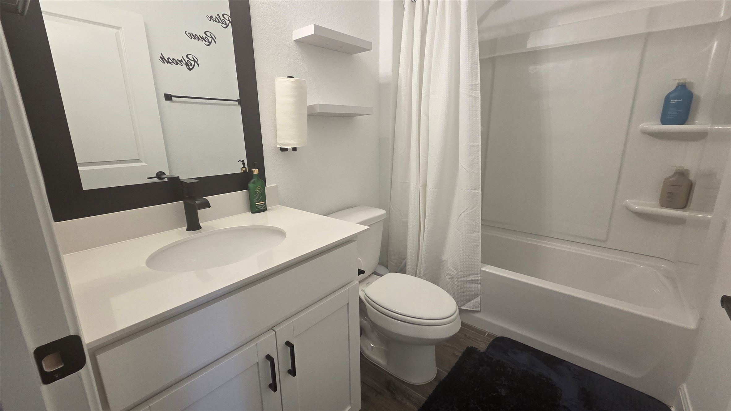 125 Raleigh Drive Georgetown, TX 78633 - Photo 8 of 30 Bathroom with vanity, shower / bath combination with curtain, and dark wood-style floors