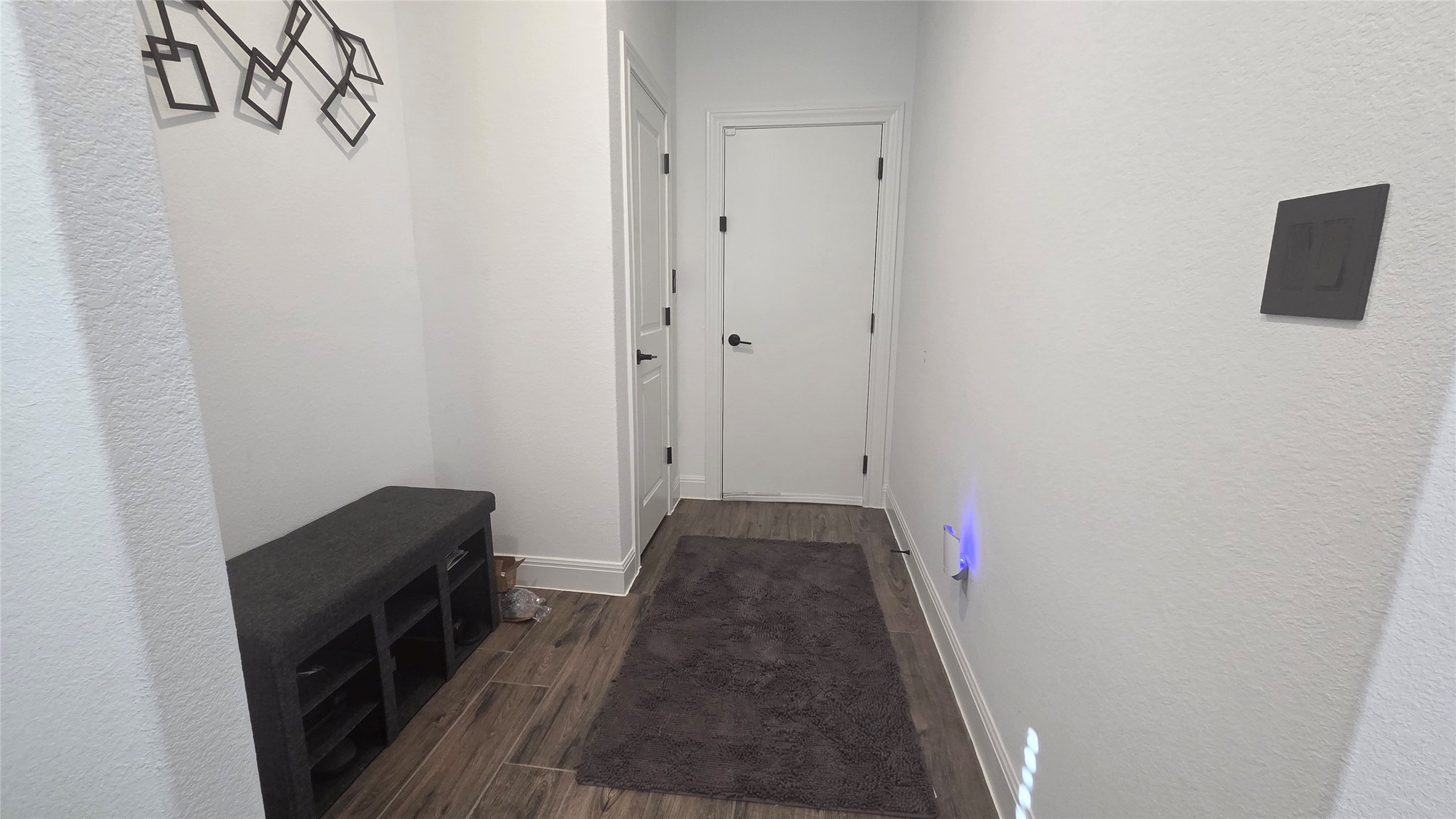 125 Raleigh Drive Georgetown, TX 78633 - Photo 10 of 30 Hallway with a textured wall and dark wood-style floors