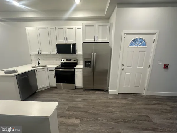 a kitchen with a refrigerator and a sink