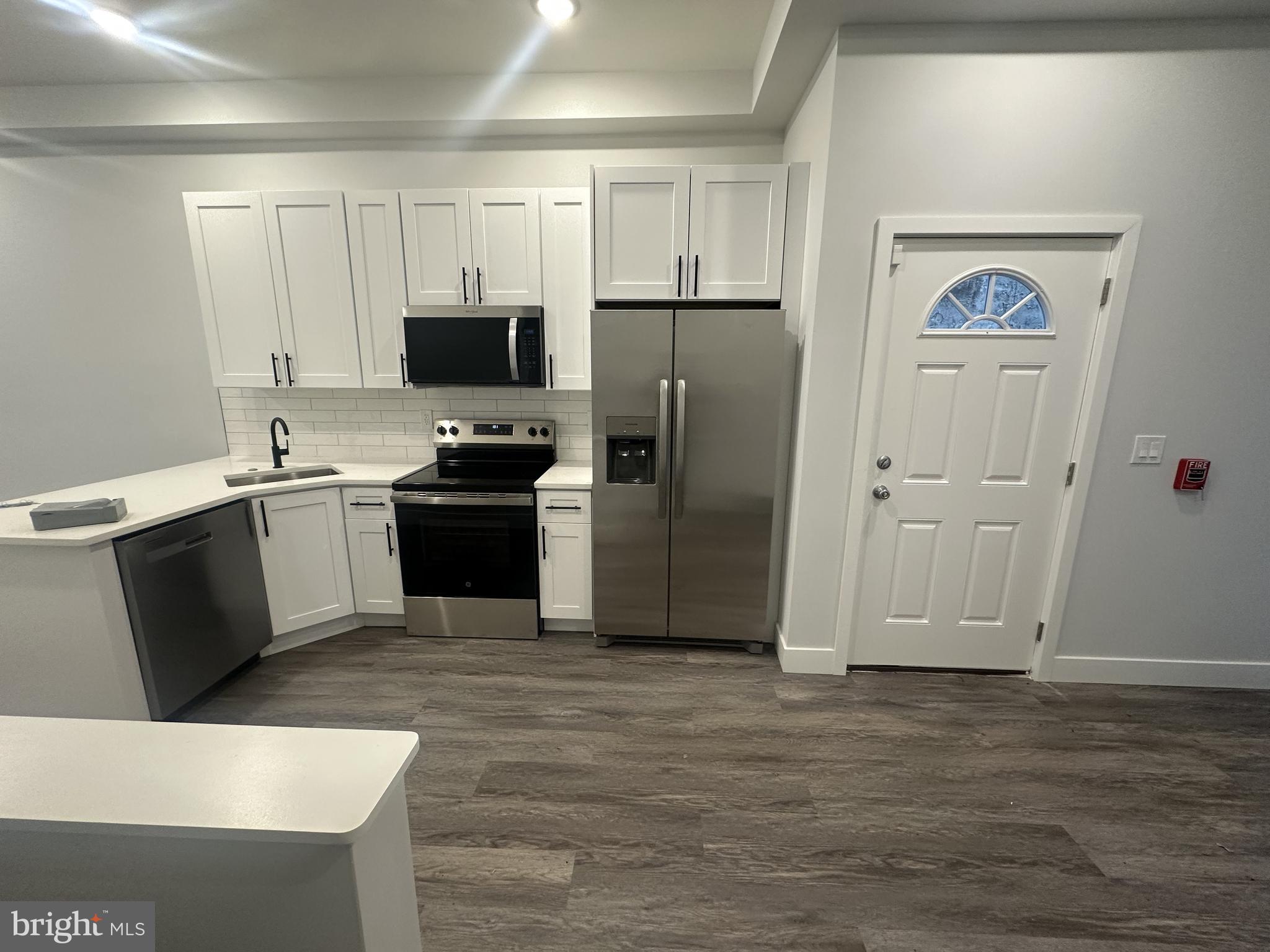 a kitchen with a refrigerator and a sink