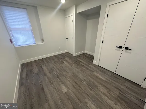 a view of a room with wooden floor and a sink