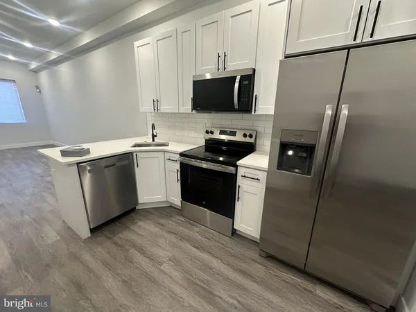 a kitchen with a sink appliances and cabinets
