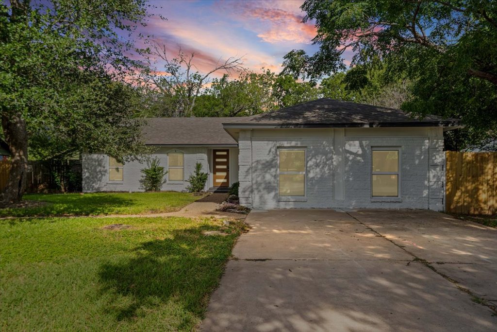 1406 North Georgetown Street Round Rock, TX 78664 - Photo 2 of 34 A classic brick exterior and mature trees define this charming home's inviting curb appeal.