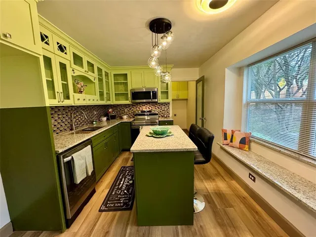 a view of a room with wooden floor and cabinet