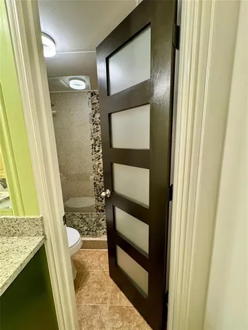 a bathroom with a toilet and shower