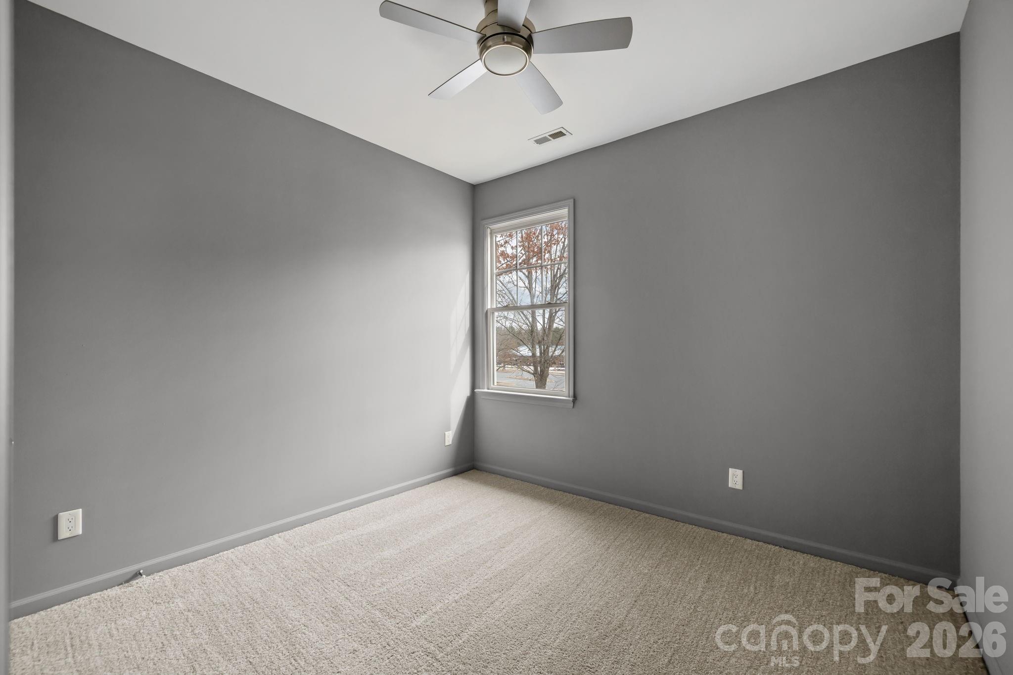 173 Blandina Court, Unit 426 Fort Mill, SC 29708 - Photo 18 of 32 an empty room with a window and a fan