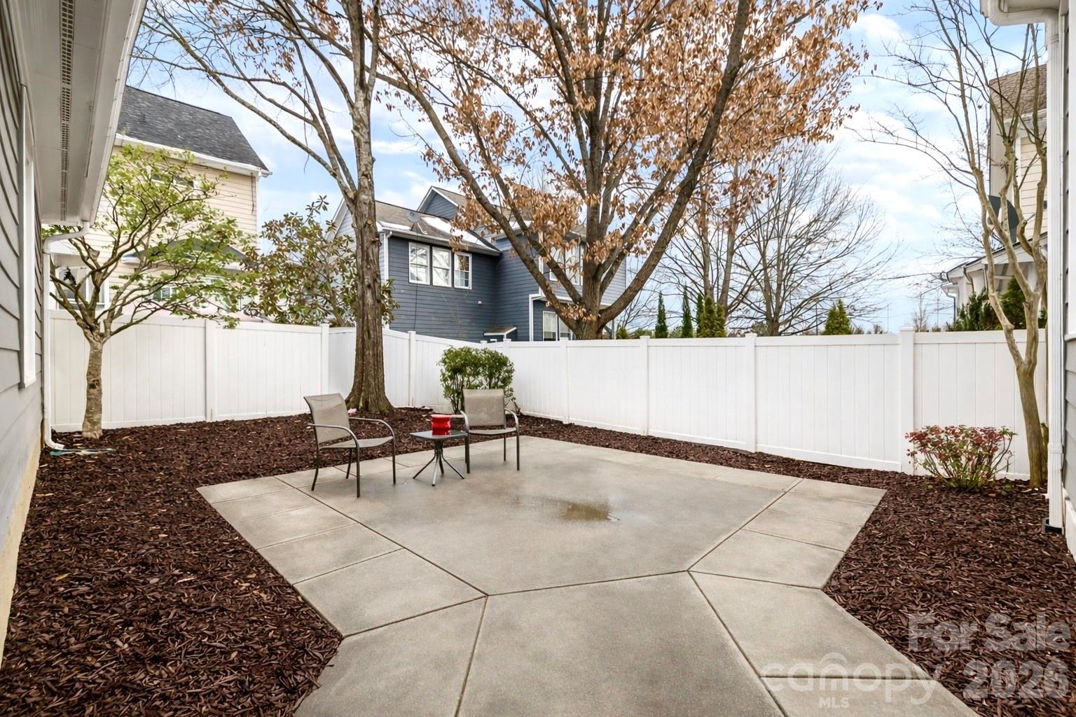 173 Blandina Court, Unit 426 Fort Mill, SC 29708 - Photo 29 of 32 a view of backyard with a table and chairs and potted plants