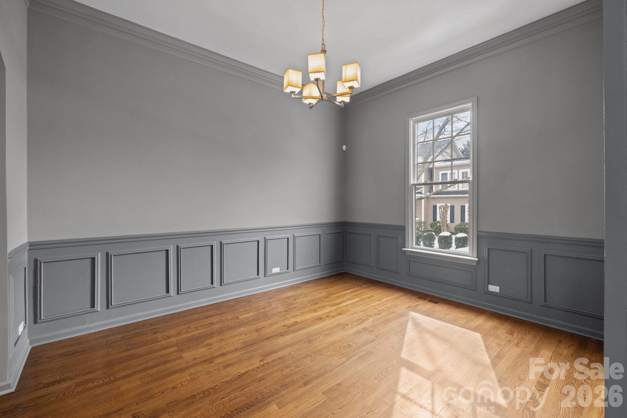 173 Blandina Court, Unit 426 Fort Mill, SC 29708 - Photo 5 of 32 a view of an empty room with a window and wooden floor
