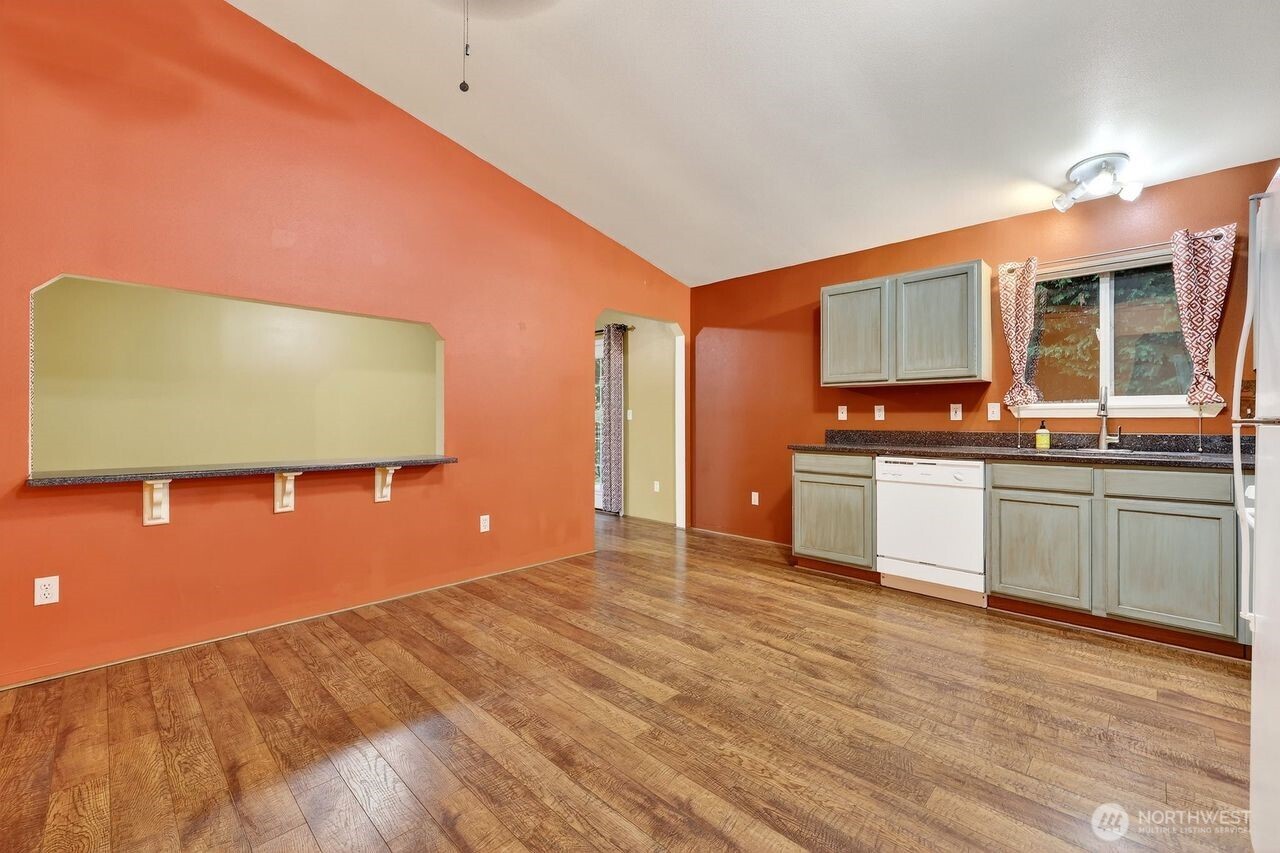 708 Marquette Avenue Snohomish, WA 98290 - Photo 11 of 33 a kitchen with stainless steel appliances a white cabinets and a wooden floor