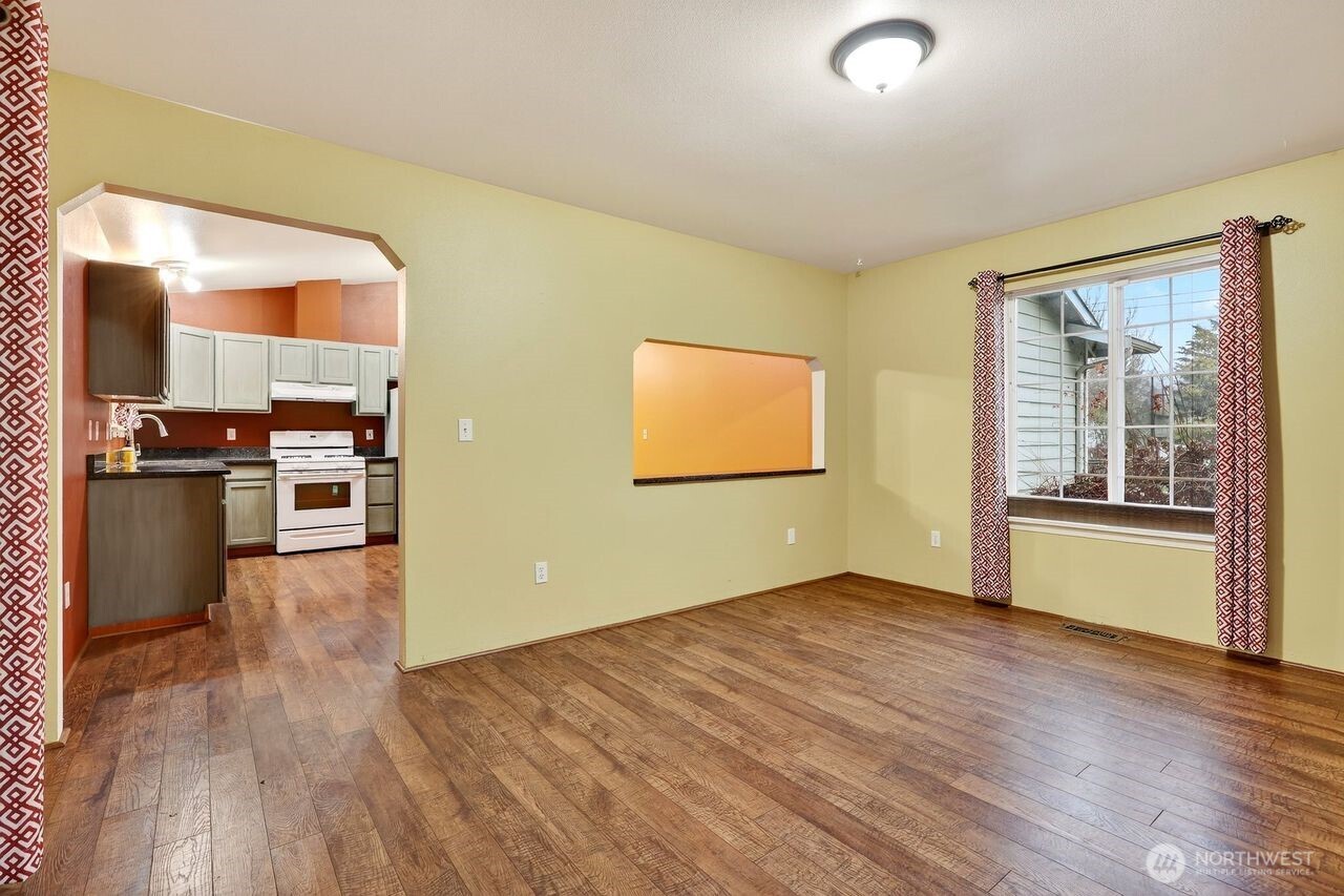708 Marquette Avenue Snohomish, WA 98290 - Photo 14 of 33 an empty room with wooden floor and windows