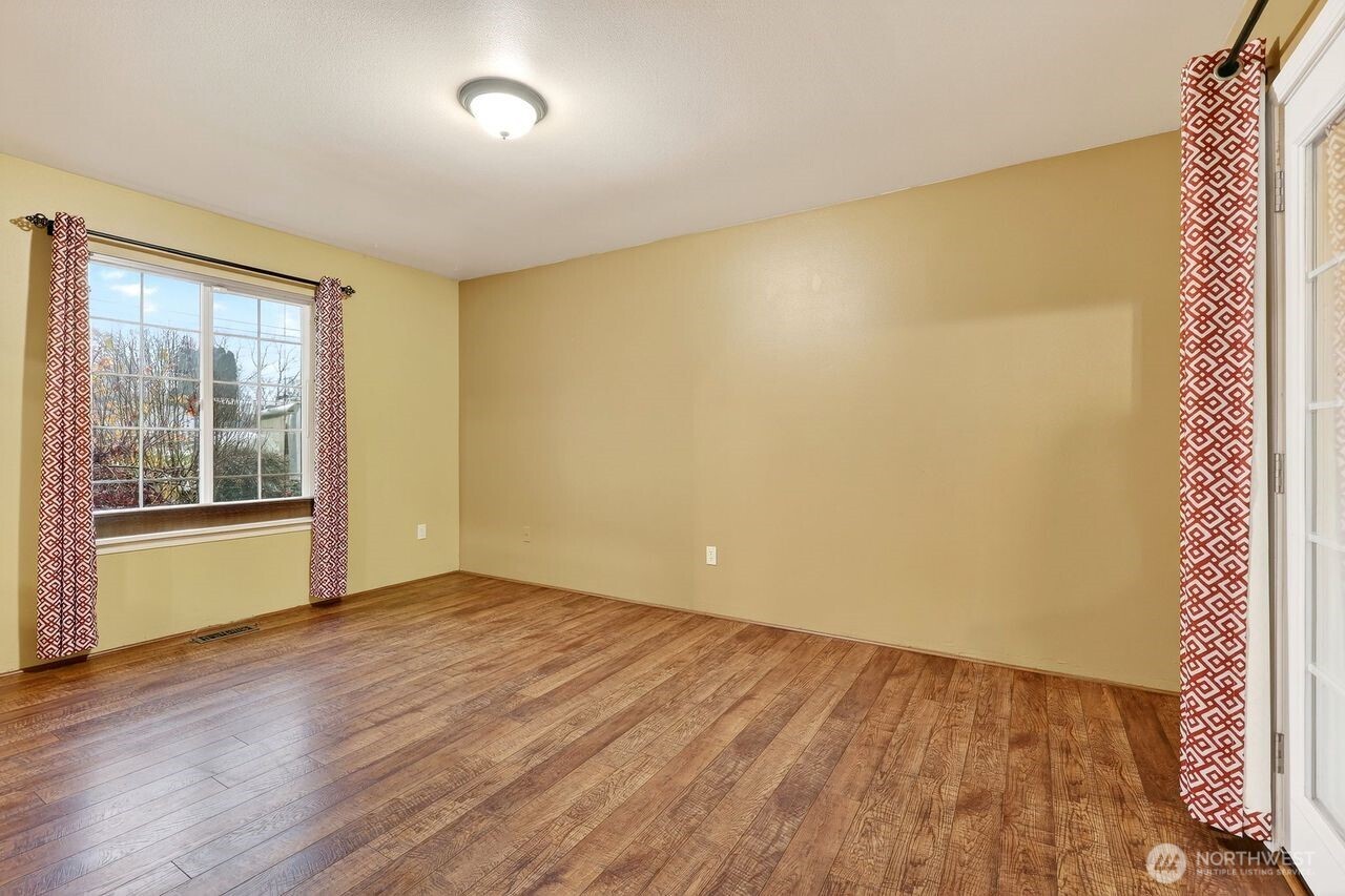 708 Marquette Avenue Snohomish, WA 98290 - Photo 15 of 33 a view of an empty room with wooden floor and a window