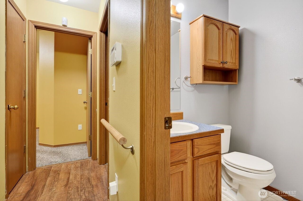708 Marquette Avenue Snohomish, WA 98290 - Photo 17 of 33 a bathroom with a granite countertop toilet sink and mirror