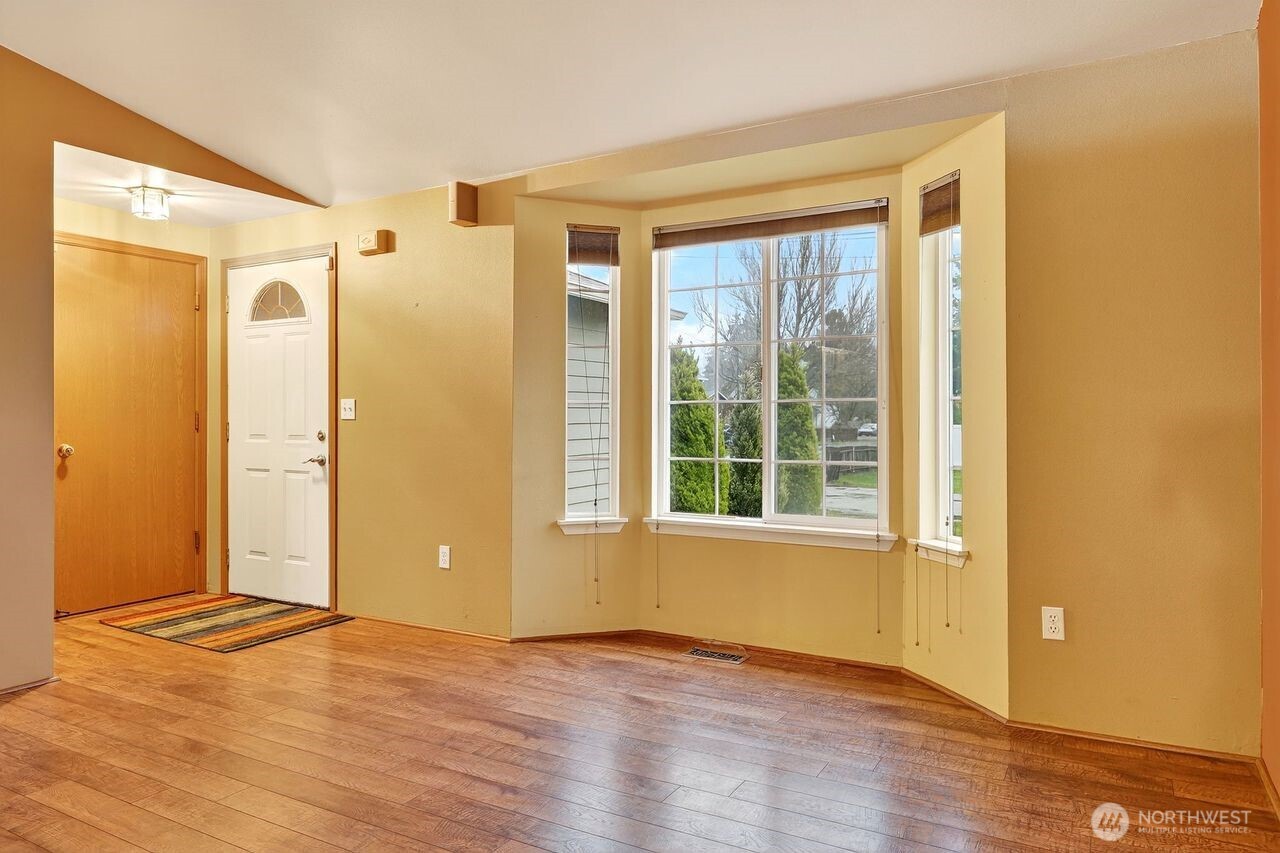 708 Marquette Avenue Snohomish, WA 98290 - Photo 5 of 33 a view of an empty room with wooden floor and a window