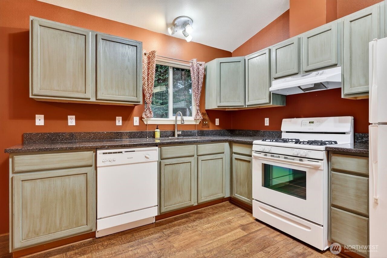 708 Marquette Avenue Snohomish, WA 98290 - Photo 8 of 33 a kitchen with stainless steel appliances granite countertop a stove a sink and a microwave
