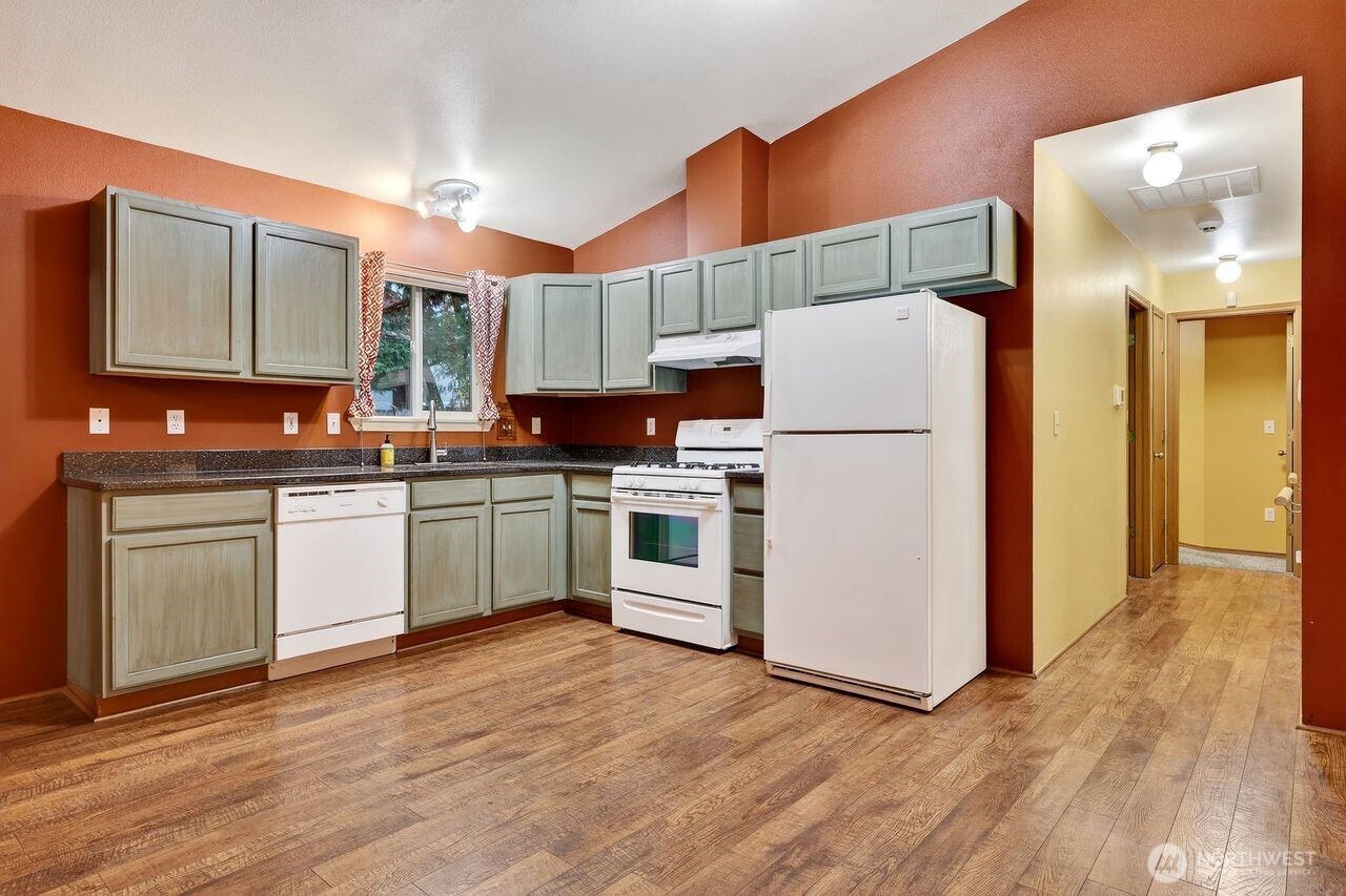 708 Marquette Avenue Snohomish, WA 98290 - Photo 10 of 33 a kitchen with a sink a refrigerator and cabinets