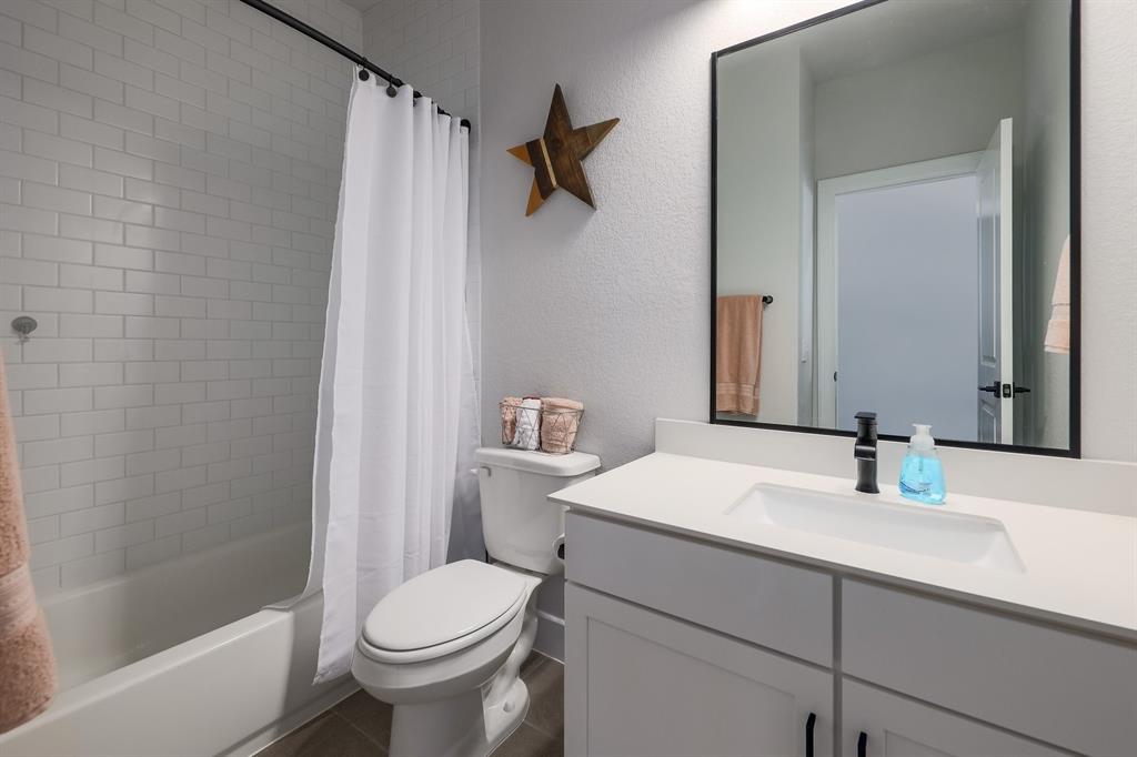 3907 Tilley Street Austin, TX 78723 - Photo 21 of 26 a bathroom with a sink toilet and shower