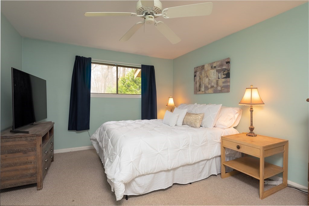 13 Mountain Gate Road, Unit 13 Ashland, MA 01721 - Photo 11 of 21 a bedroom with a bed and a flat screen tv