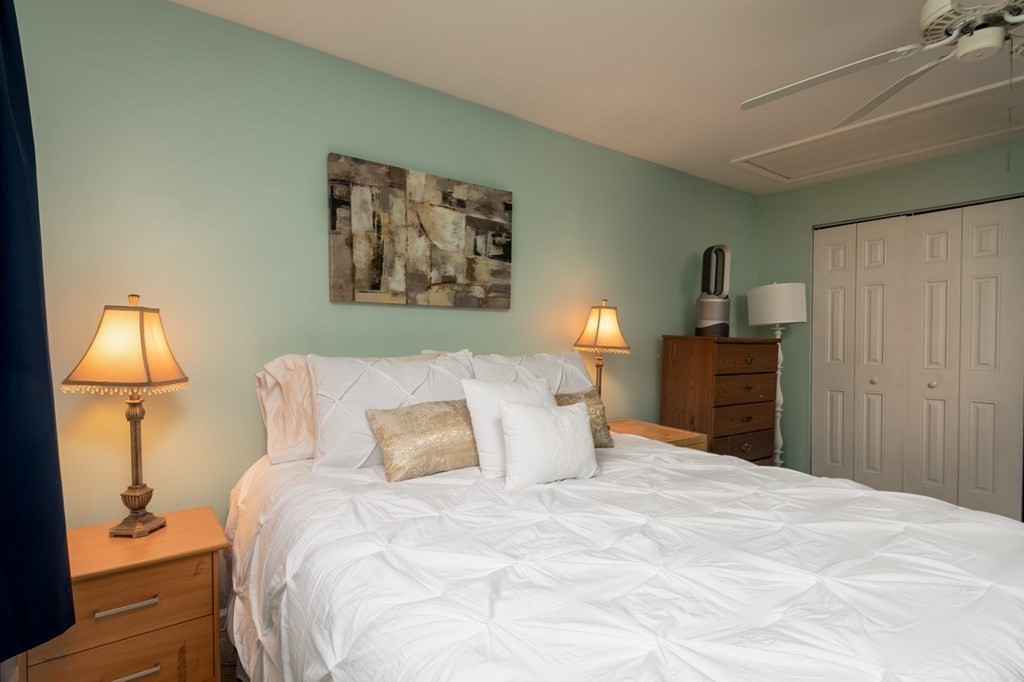 13 Mountain Gate Road, Unit 13 Ashland, MA 01721 - Photo 12 of 21 a bedroom with a bed and a lamp
