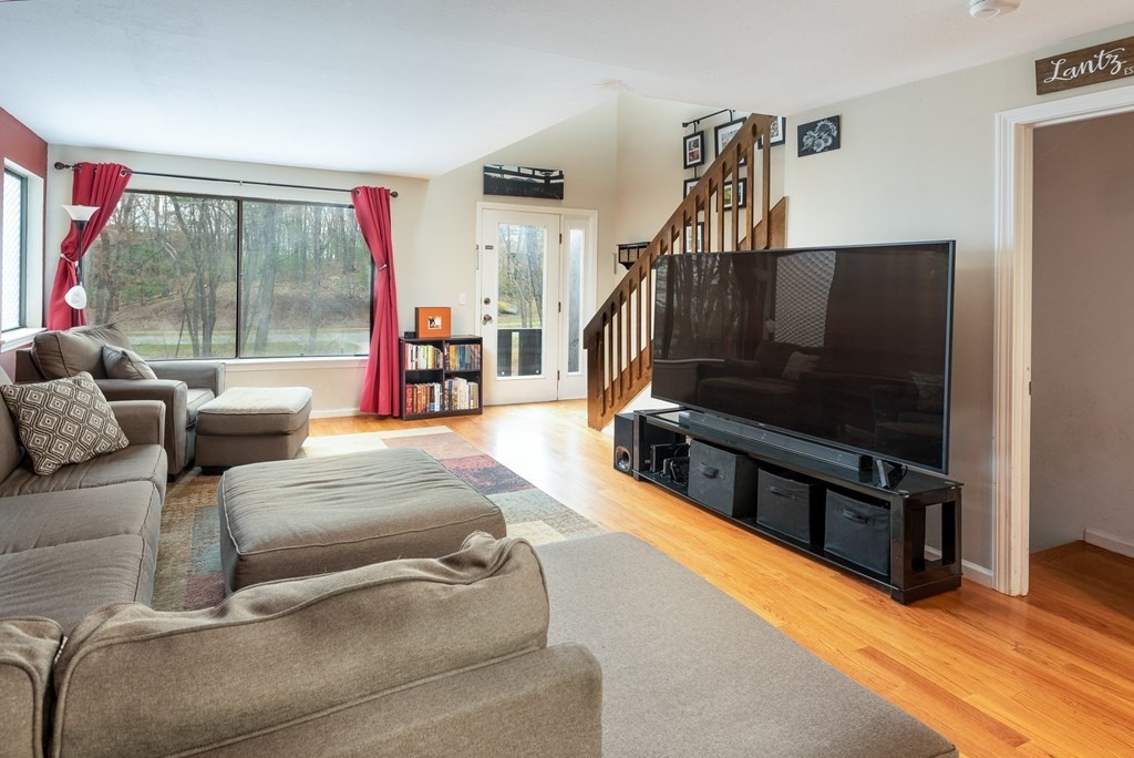 13 Mountain Gate Road, Unit 13 Ashland, MA 01721 - Photo 3 of 21 a living room with furniture and a flat screen tv
