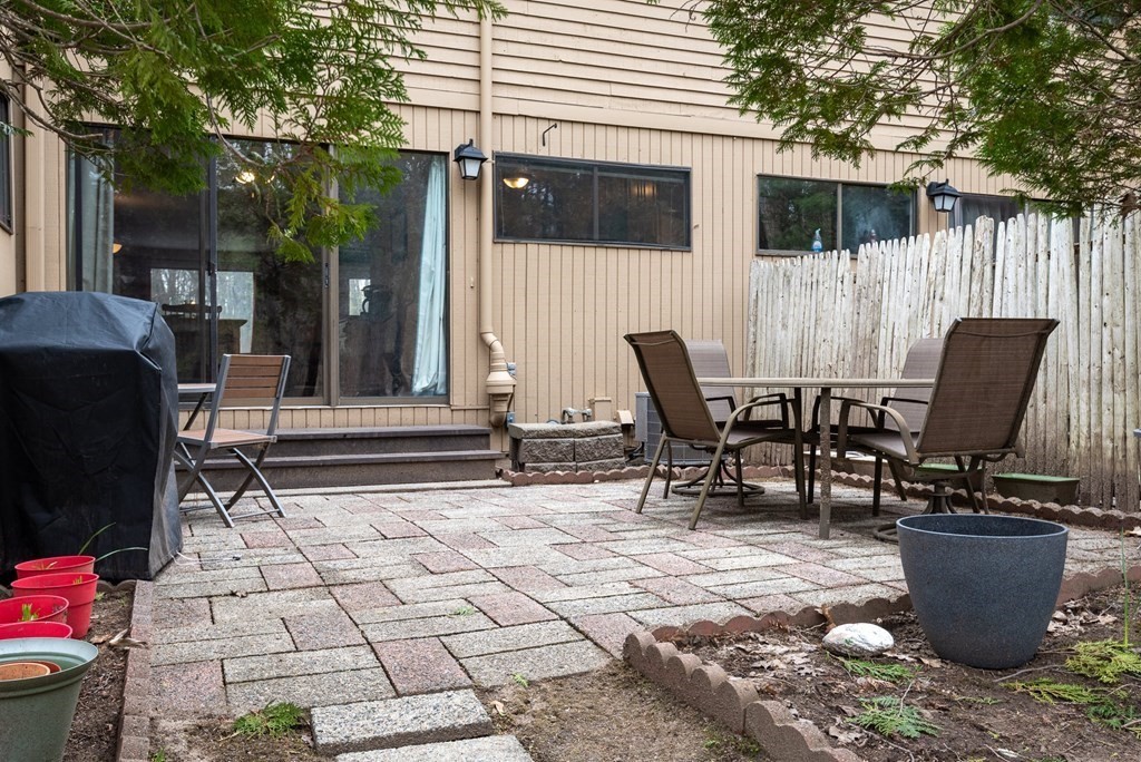 13 Mountain Gate Road, Unit 13 Ashland, MA 01721 - Photo 5 of 21 a view of a chairs and table in backyard