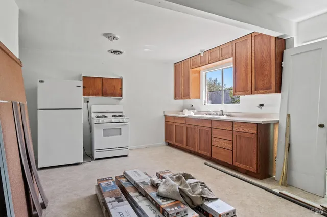 a kitchen with a sink appliances and cabinets