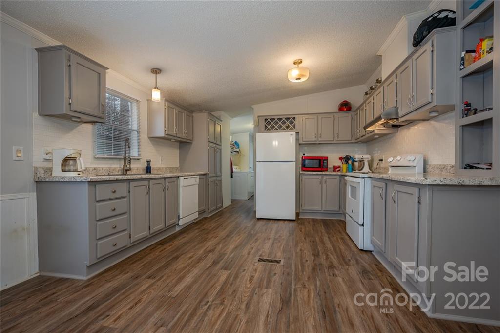 1139 Piney Knob Road Rutherfordton, NC 28139 - Photo 15 of 37 a kitchen with cabinets a sink and wooden floor