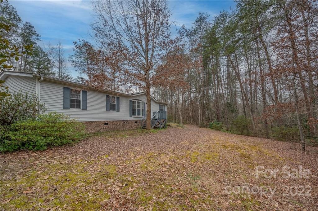 1139 Piney Knob Road Rutherfordton, NC 28139 - Photo 4 of 37 a backyard of a house with large trees and wooden fence