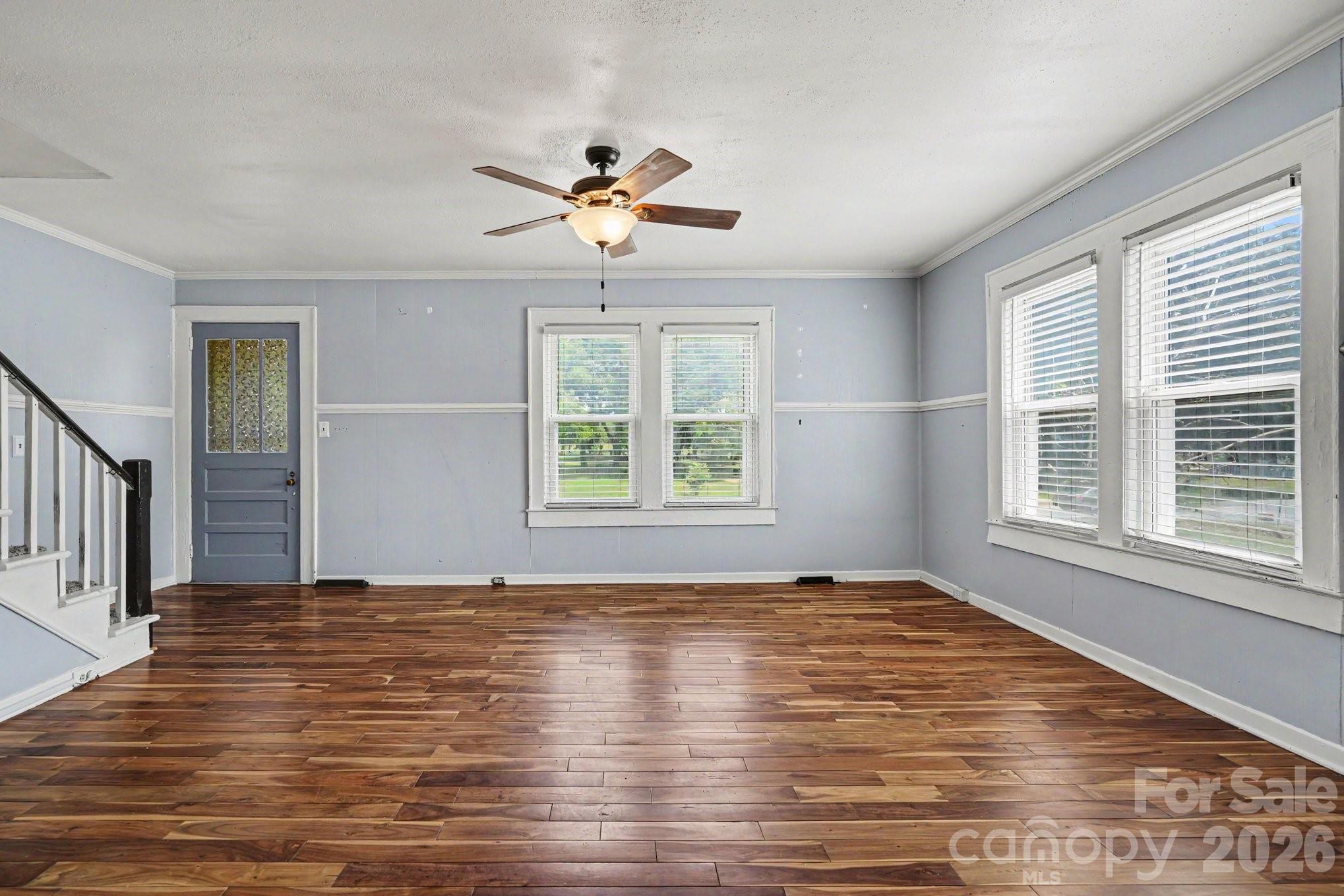 24359 Ridgecrest Road Locust, NC 28097 - Photo 5 of 26 a view of an empty room with a window and wooden floor