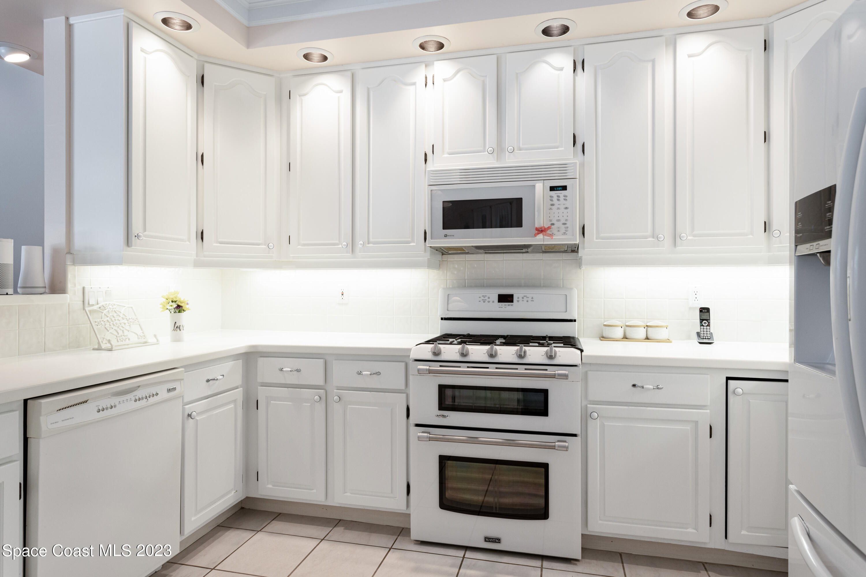 442 Sanderling Drive Indialantic, FL 32903 - Photo 15 of 45 a kitchen with cabinets stainless steel appliances and sink
