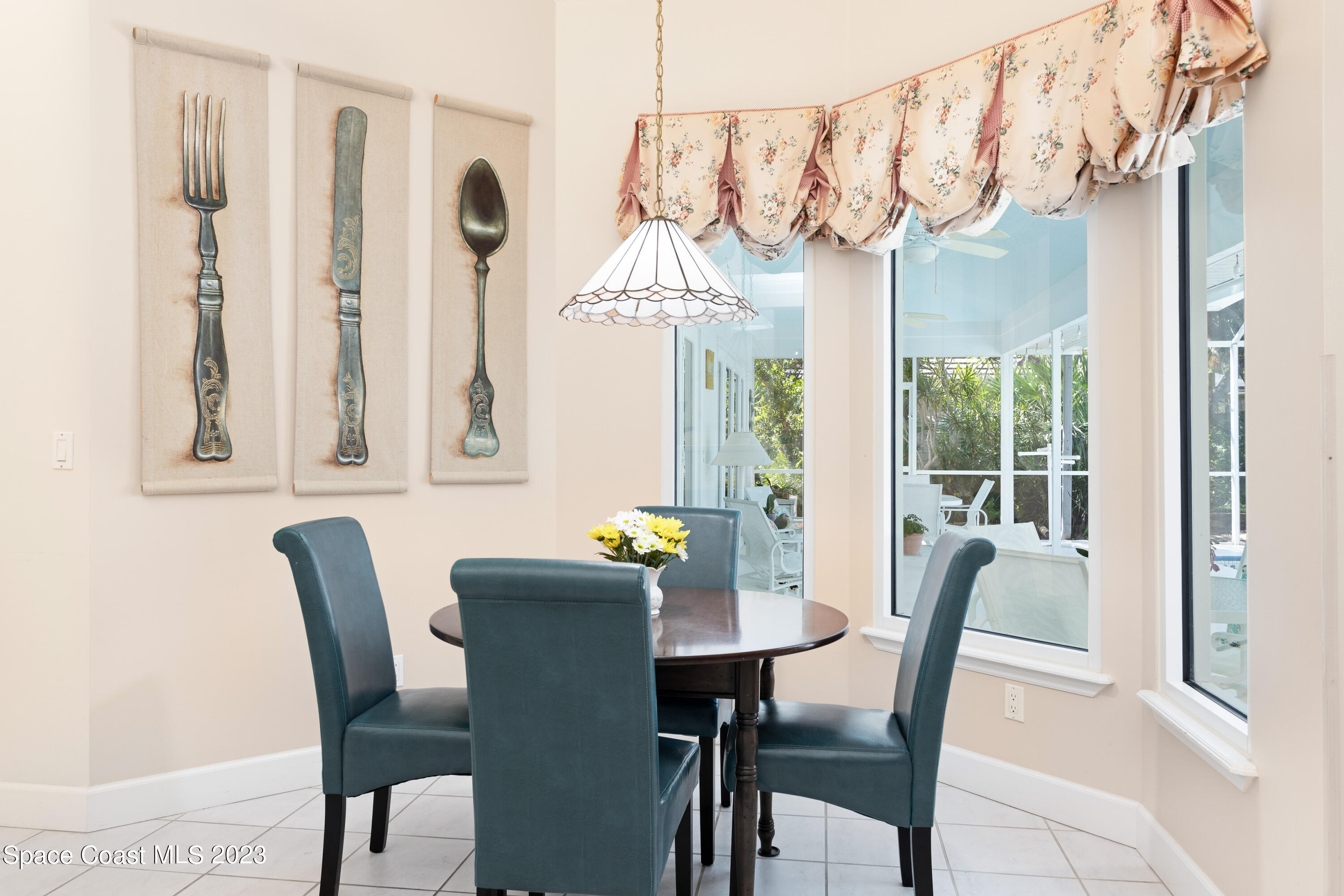 442 Sanderling Drive Indialantic, FL 32903 - Photo 18 of 45 a dining room with furniture a chandelier and wooden floor