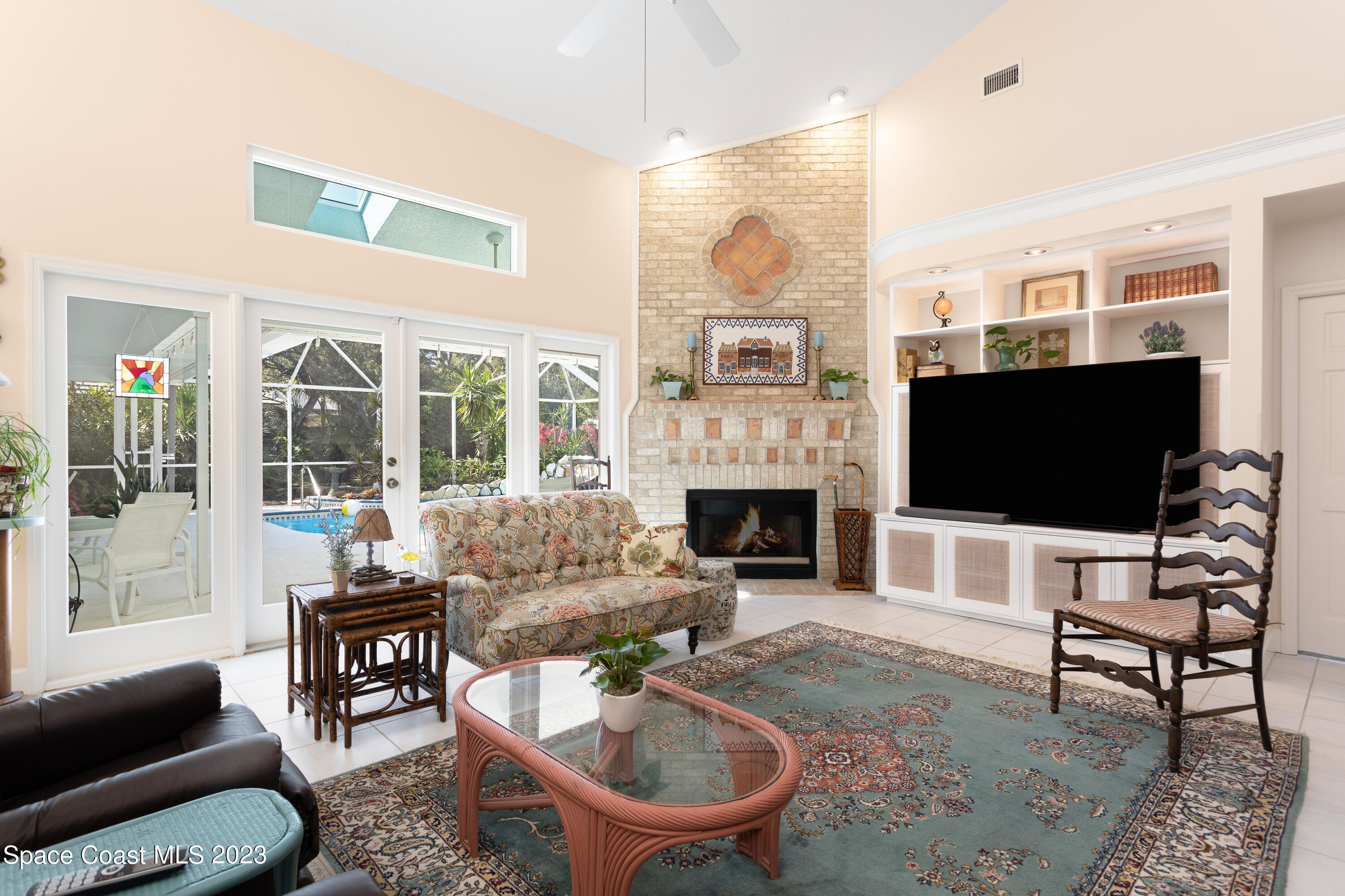442 Sanderling Drive Indialantic, FL 32903 - Photo 19 of 45 a living room with furniture a flat screen tv and a fireplace