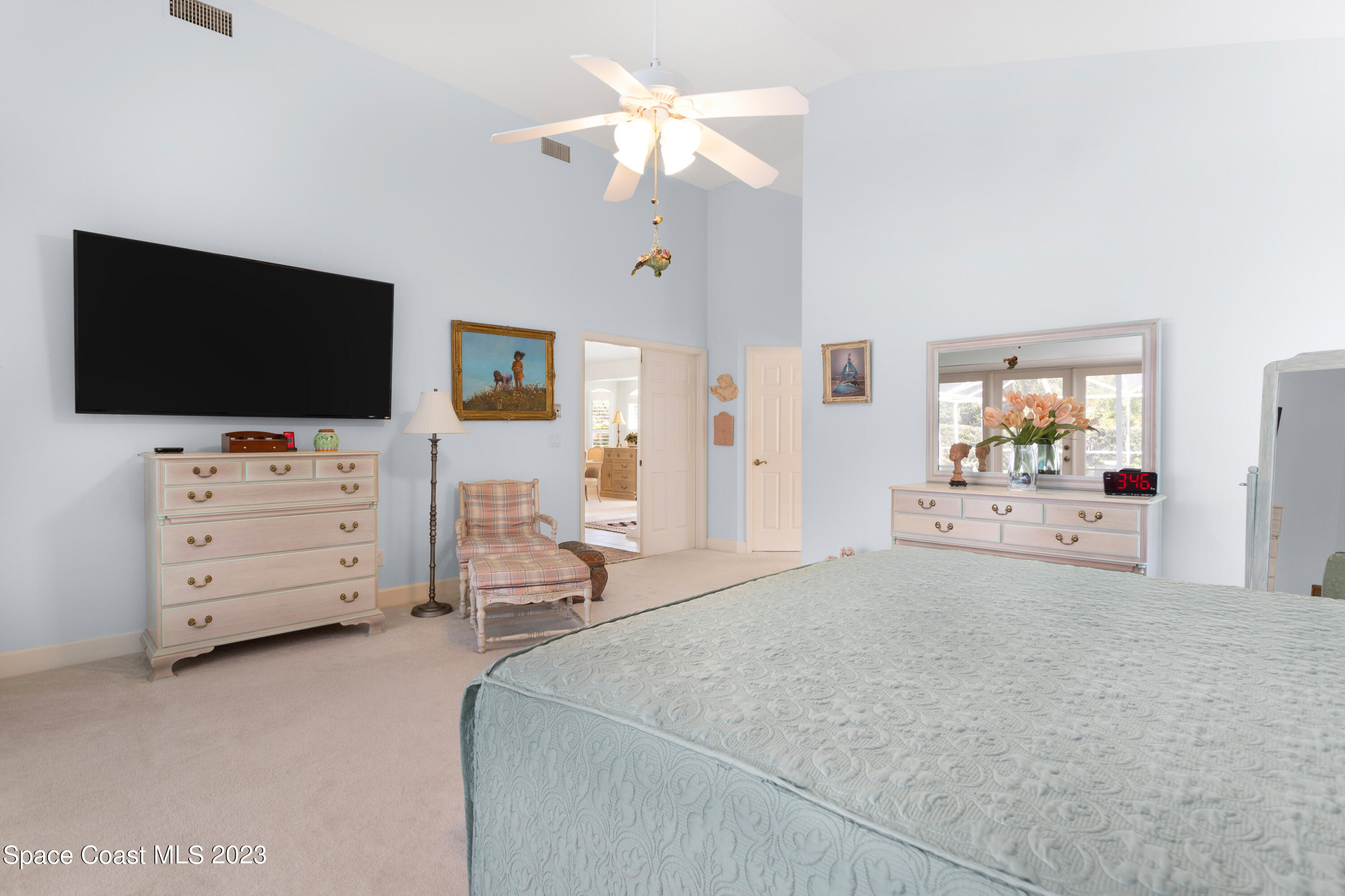442 Sanderling Drive Indialantic, FL 32903 - Photo 22 of 45 a spacious bedroom with a bed and a flat screen tv