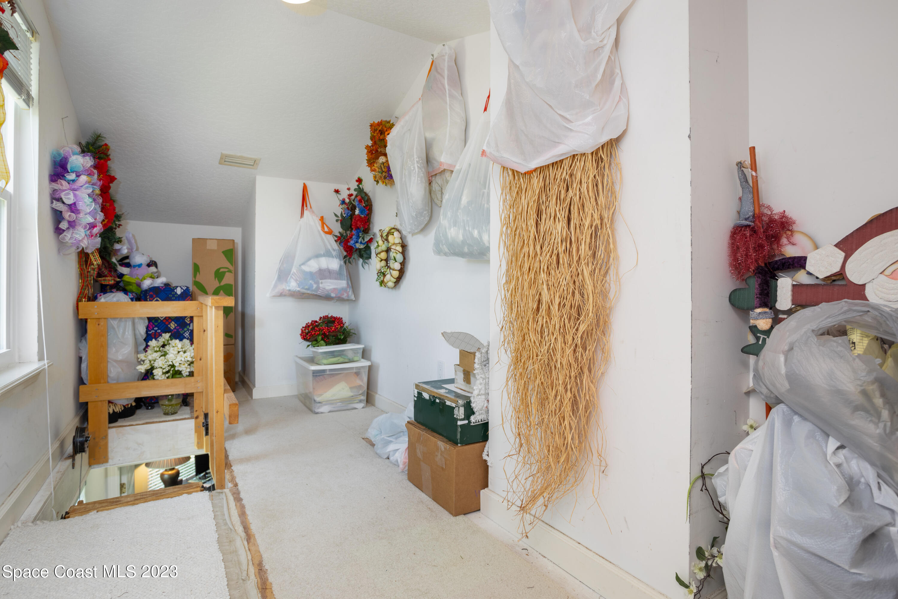 442 Sanderling Drive Indialantic, FL 32903 - Photo 35 of 45 a room with a book shelf and a couch