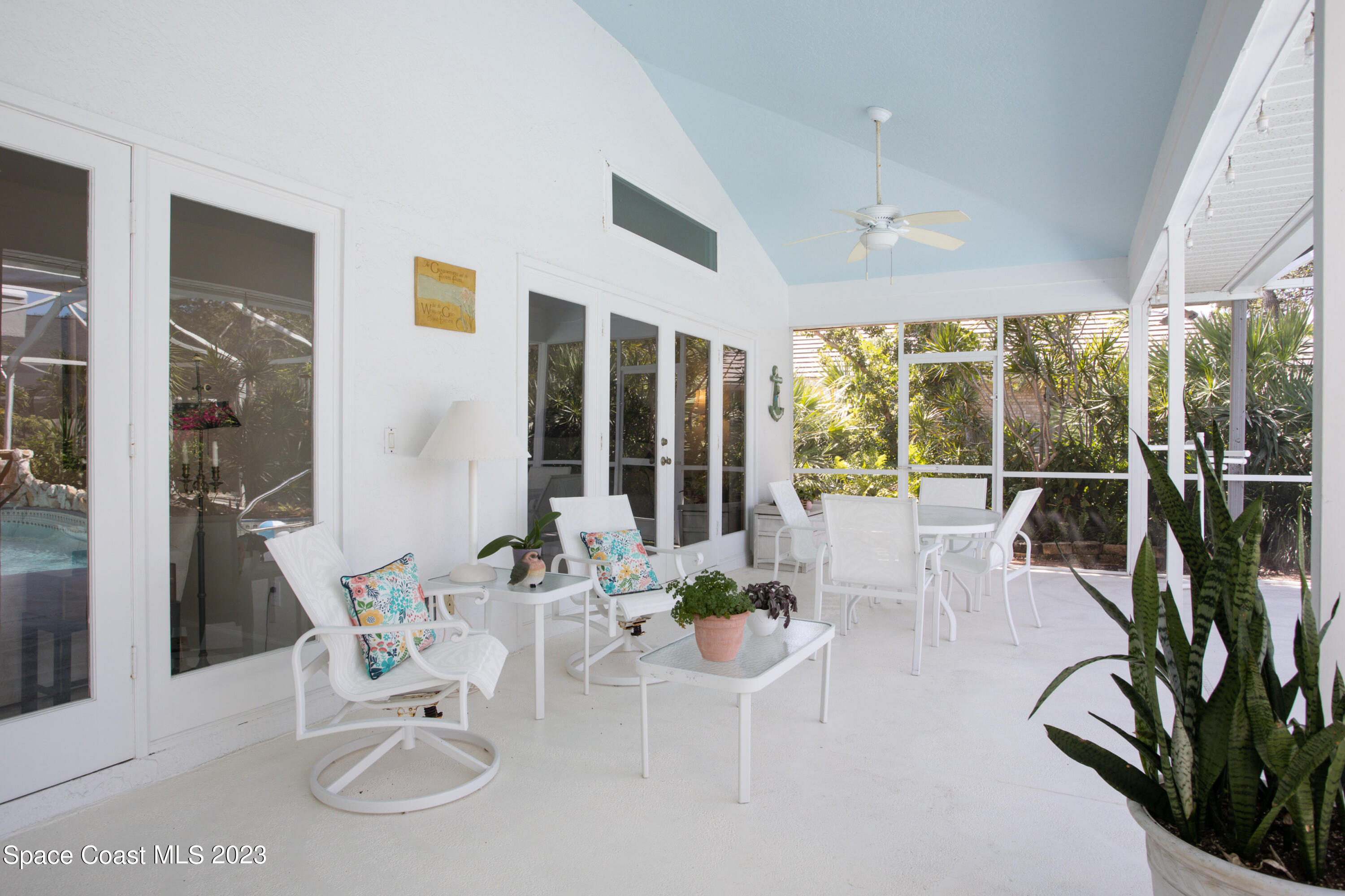 442 Sanderling Drive Indialantic, FL 32903 - Photo 36 of 45 a living room with furniture a large window and wooden floor