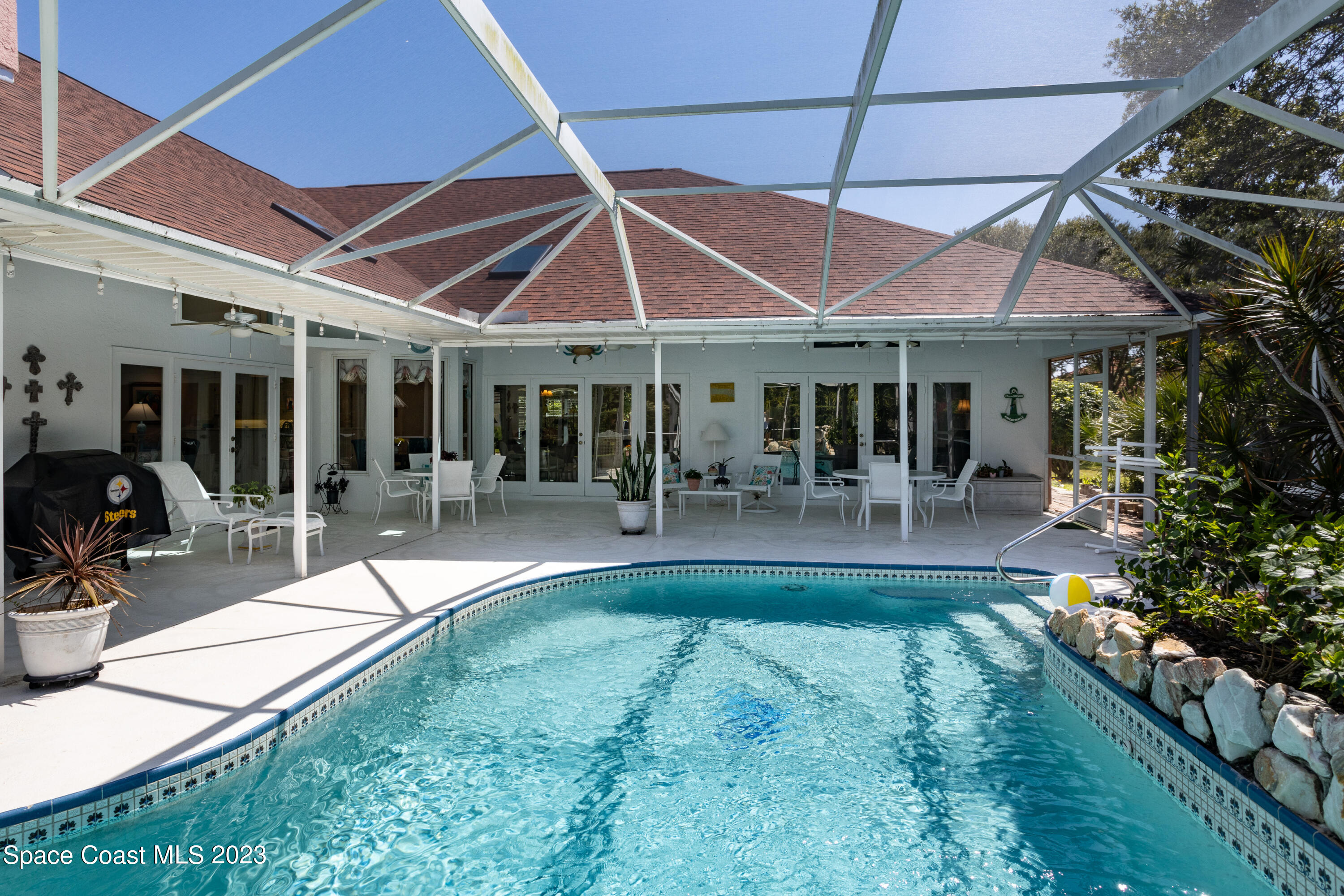 442 Sanderling Drive Indialantic, FL 32903 - Photo 40 of 45 a view of a patio with table and chairs under an umbrella