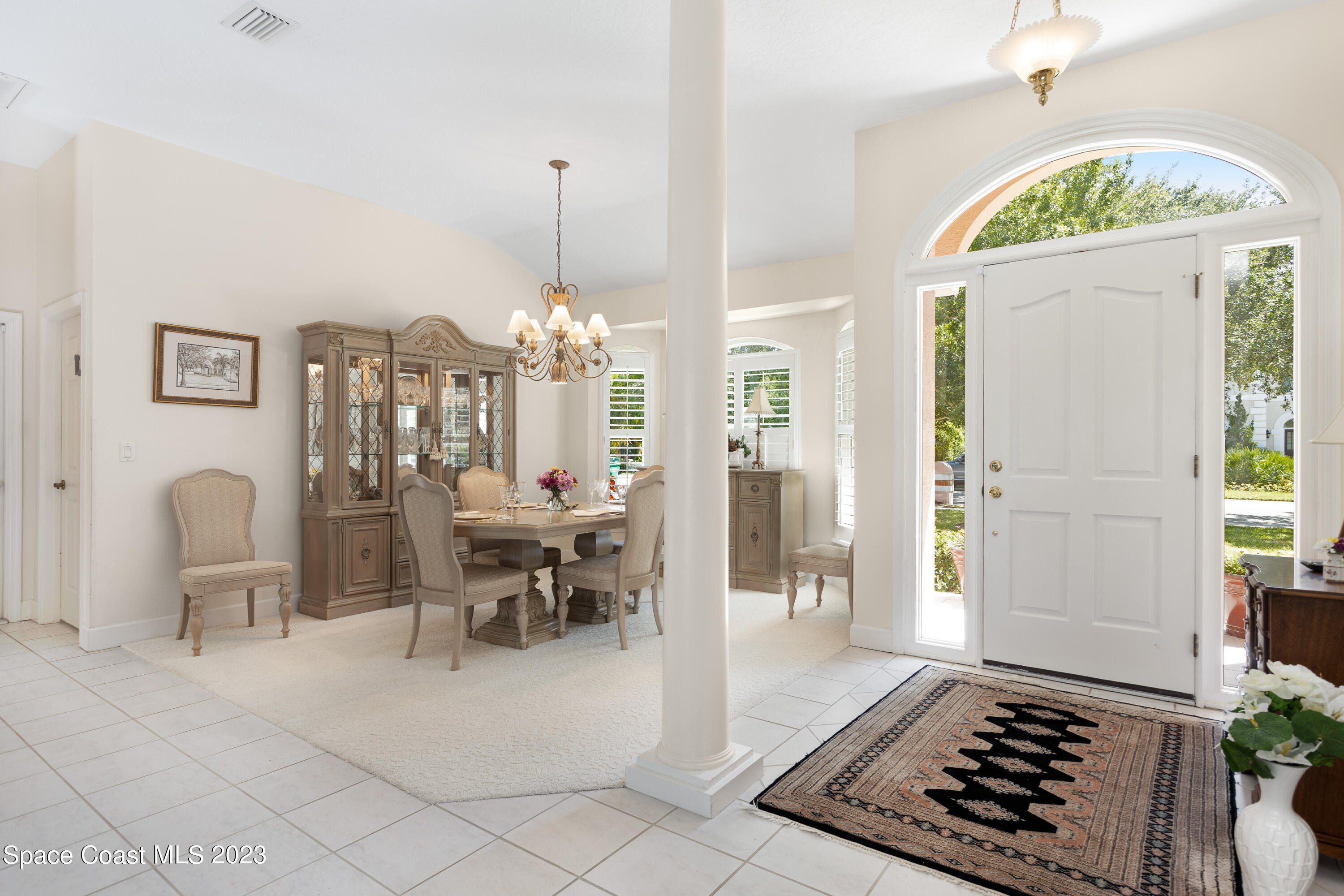 442 Sanderling Drive Indialantic, FL 32903 - Photo 7 of 45 a view of a hallway with dining room and chandelier