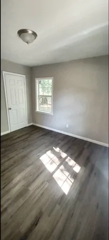 a view of an empty room and wooden floor