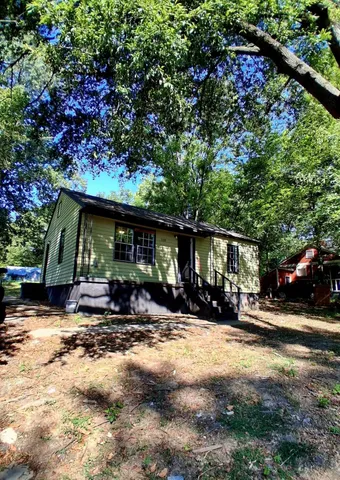a view of a outdoor space with patio area and furniture