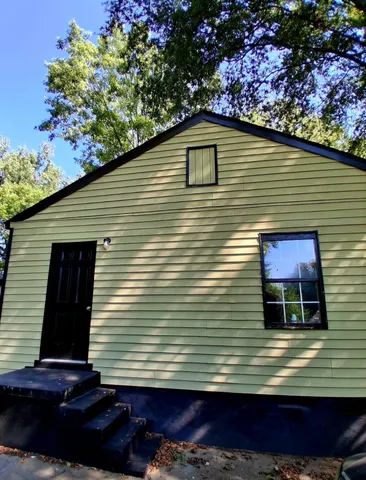 a green field with trees in the background