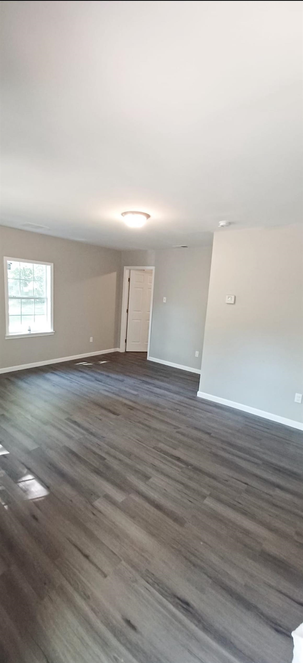 3189 Morningside Street Memphis, TN 38127 - Photo 8 of 14 a view of an empty room with wooden floor and a window
